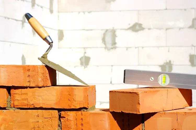 Bricks, a trowel and a spirit level on a job site