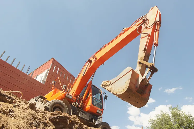 An excavator digging on a lot